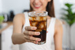 © Pormezz - person smiling and holding a glass of soft drink soda