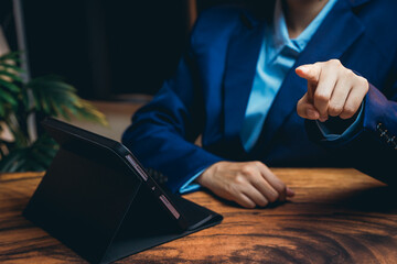 Poster - Business Professional Pointing at Tablet with Focused Expression in Modern Office Setting