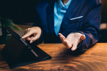 Poster - Business Professional Engaging in Discussion While Using a Tablet on a Wooden Desk in an Office Setting