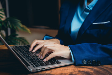 Poster - Business Professional Working on Laptop in Modern Office Environment with Elegant Suit and Stylish Background