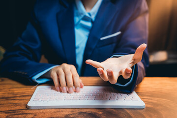 Poster - Business Professional Gesturing with Open Hand While Working on Keyboard at Desk in Office Environment