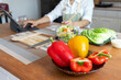 © thatinchan - young woman preparing bell Pepper as a breakfast ingredient and ready for healthy cooking and on the table there are vegetables that are healthy organic ingredients. healthy food preparation ideas