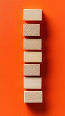 Poster - Wooden Blocks Stacked on Orange Background Top-Down Minimalist Style for Business Strategy Concept and Creative Teamwork