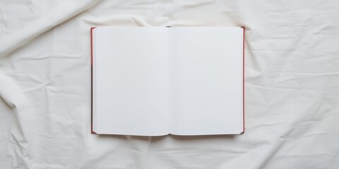 Poster - An open blank notebook with a red spine lying on a white wrinkled fabric background, top view