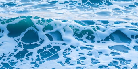 Poster - A close up shot of a turquoise ocean wave with white foam creating intricate patterns on the water