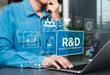 © Supatman - R and D, Research and Development Innovation Technology Concept. A person working on laptop with icons and text R and D, symbolizing innovation, analysis, and scientific business development processes