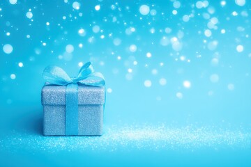 Wall Mural - A wrapped gift box with blue ribbon and bow on solid blue background, perfect for celebrations and promotions.
