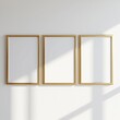 © Georgia - wall art poster frames gold frame decor gallery canvas painting print mockup mockups design three digital artwork printed shadow white wall natural sunlight golden minimalist minimal blank empty space