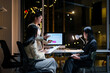 © Crystal - Business team working late at night in office using desktop computer analyzing financial charts