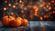 © Gautam - Orange pumpkins on rustic wood table warm bokeh glowing lights autumn mood image