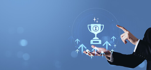 Poster - Businessman interacting with digital trophy icon and upward arrows on blue background representing success and achievement concept in technology interface.
