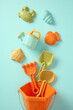 © ADDICTIVE STOCK - Colorful plastic beach toys set flat lay on blue background