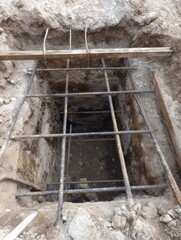 Poster - Excavation Pit Showing Reinforcing Bars and Open Margins Above in Construction Site During Daytime