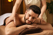 © New Africa - Man receiving relaxing massage in spa salon