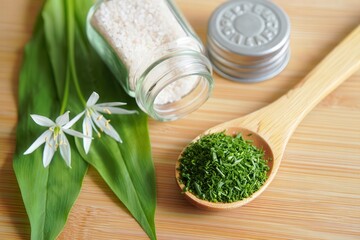Poster - A wooden cutting board with various herbs and spices in glass jars and a wooden bowl.
