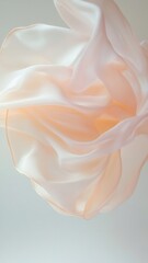 Poster - delicate, flowing piece of sheer fabric crumpled, soft peach and white in The fabric appears to be gently tones. creating an elegant, airy look