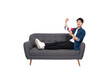 © STOCK88PHOTOGRAPHER - Full body image of young Asian man using hand speaker sitting on sofa on white background