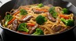 © Firman Dasmir - Delicious beef and broccoli lo mein simmering in a cast iron skillet