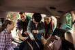 © Davor - Family packing car trunk for road trip with kids outdoors