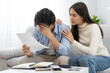 © Pormezz - Family financial concept, Stressed wife and husband have a problem to pay loan can not pay credit card debt.