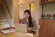 © snowing12 - Asian woman works with laptop at home office. Young entrepreneur analyzes data, making reports. Businesswoman sitting and using a computer.