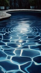 Poster - Tranquil ripple patterns on azure pool water, reflections shimmering with radiant sunlight, garden pots and dark stone in the background.