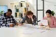 © Mediaphotos - Group of students studying foreign languages in classroom, focusing on their textbooks and notes. Bright environment with educational materials, fostering discussions and collaborative learning