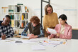 © Mediaphotos - Multiracial group of students and teacher studying foreign languages in well-lit classroom with diverse teaching materials. Collaborative learning environment seen with various study aids around