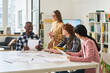 © Mediaphotos - Enthusiastic group of students collaborating on foreign language exercises at modern classroom with large windows. Instructor engaging class, fostering interactive learning environment