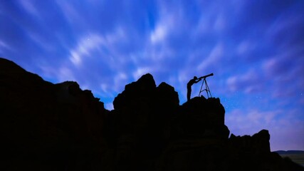 Wall Mural - person silhouette looking at telescope silhouette stands on the hill on the milky way galaxy an back