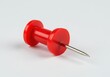 © MdMostafizur - A close up view of a single, vibrant, crimson pushpin resting on a plain backdrop