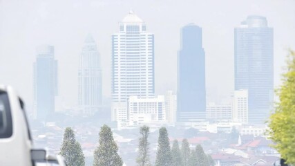Poster - Cityscape under Haze: A modern city skyline shrouded in a hazy atmosphere, showcasing the urban landscape with a touch of mystery and subdued color, presenting a contemporary metropolitan panorama.