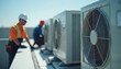 © Viktor - HVAC technicians install air conditioning units on commercial building rooftop. Men in workwear set up cooling system, ensuring efficient climate control. Expertise, service, maintenance.