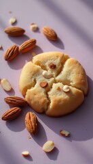 Poster - Almond cookie on a lilac background with almonds, crumbly baked treat in warm, sunny, soft lighting