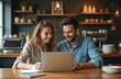 © Viktor - Two happy business owners working laptop cafe. Smiling man and woman in casual attire discuss business strategy. Friends work on project, looking finance data, enjoying teamwork and modern tech.