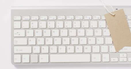 Poster - overhead view of brown sale tag on computer keyboard
