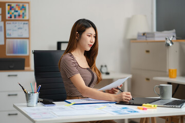 woman developer or designer thinking about mobile app interface wireframe design with customer breif and color code at office..