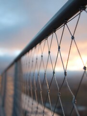 Leinwandbilder - Detailed View of Safety Netting and Guardrails With Soft Upper Lighting at Sunset