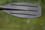 black oar with droplets of water