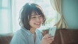 © Aruzimakon - 自宅でスマートフォンを使う笑顔の女性 #03