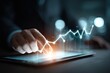 © Muhammad - Business hand interacting with a digital graph on tablet, illustrating growth and success