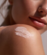 © Boadicea - Female shoulder with moisturizing cream swatch, close-up