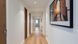 © Cherrin - Renovation of a modern home concept. Modern hallway with wooden flooring and framed artwork on the wall.