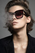 © eugenepartyzan - Smoking Beautiful woman with short hair in sunglasses