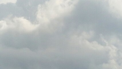 Cloudy skies paint the atmosphere with softness and subtle drama, diffusing light and muting the landscape below