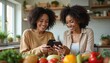 © Maryna - Two black women smiling, using phones in kitchen. Fresh vegetables on table, healthy food concept. Modern tech for diet, meal planning, weight loss. Online nutrition app. Modern digital lifestyle.