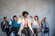 © NDABCREATIVITY - Excited overjoyed diverse business people, team celebrate corporate victory together in office