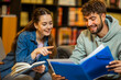 © Mediteraneo - Two Students Studying and Reading from Folder in Library