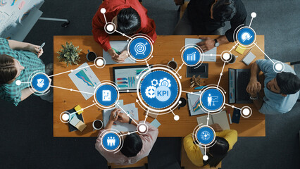 Poster - A diverse business team collaborates around a table analyzing key performance indicators with visual data. Charts and technology illustrate strategy planning and insights. Amity