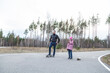 © Mariia - Father and his little daughter ride skateboards in the forest